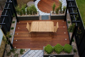 Dark wood contrasts with white granite paving