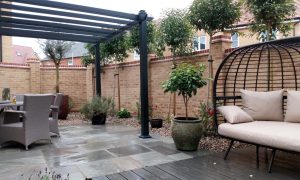 Mediterranean influenced courtyard design with natural grey stone paving and specimen plants